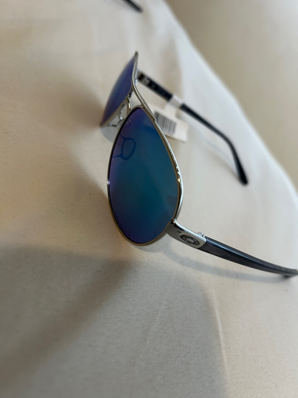 Oakley Silver Frame Sunglasses with Blue Mirrored Lenses
